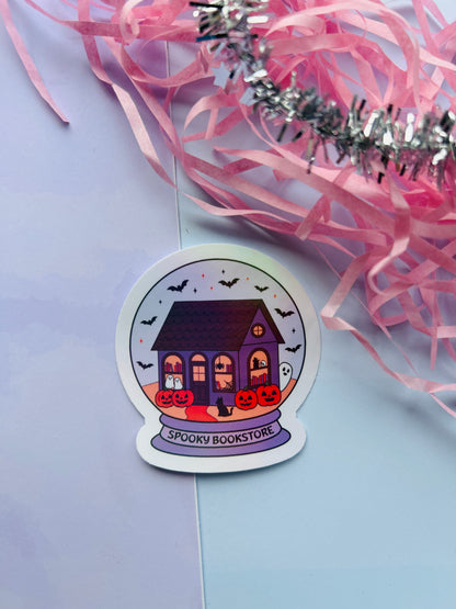 Halloween-themed sticker of a purple house with pumpkins on a light purple background.