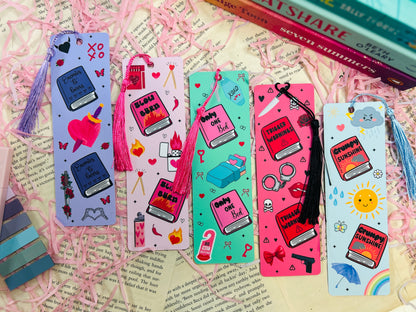 Single illustrated tassel bookmark inspired by romance book tropes, including designs like "Slow Burn" and "Trigger Warning" with bright colours and fun details.