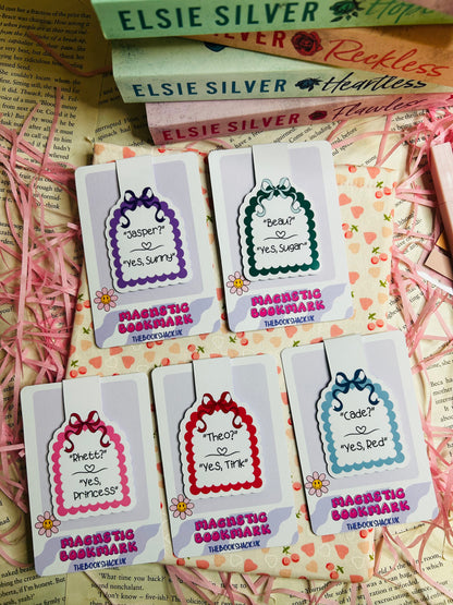 Collection of magnetic bookmarks featuring romantic quotes and character names like 'Jasper,' 'Beau,' 'Rhett,' 'Theo,' and 'Cade' on pastel designs with scalloped edges and bow accents. 