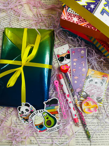 Mystery book bundle for kids with a surprise book, bookmark, bubbles, stickers, and packaging on pink shredded filler.