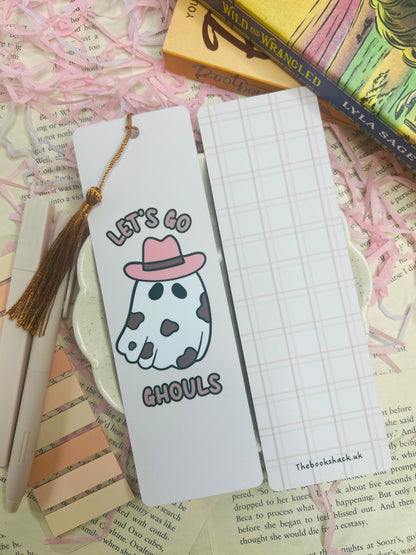 Double-sided bookmark: one side shows a cow-print ghost with a pink cowboy hat and text “Let’s Go Ghouls,” the reverse side has a pastel pink plaid pattern.