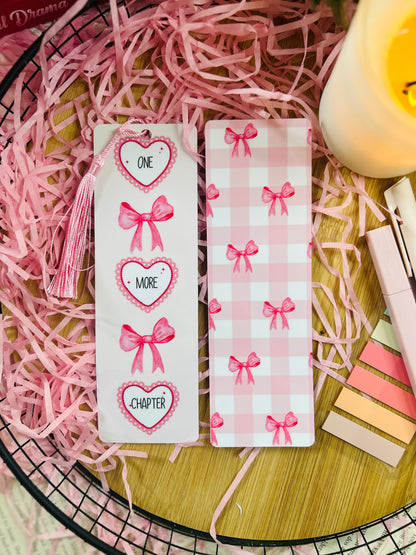 pink girly bookmark, double sides design, one side it says 'one more chapter' in hearts and bows, the other side is a checked pattern with bows