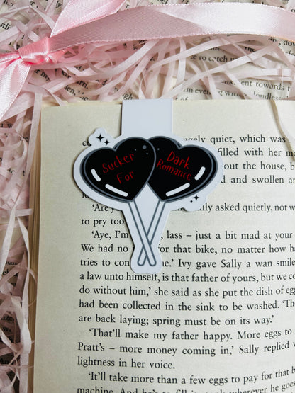 Magnetic bookmark with a bold design showcasing two black heart-shaped balloons that read 'Sucker for Dark Romance.'