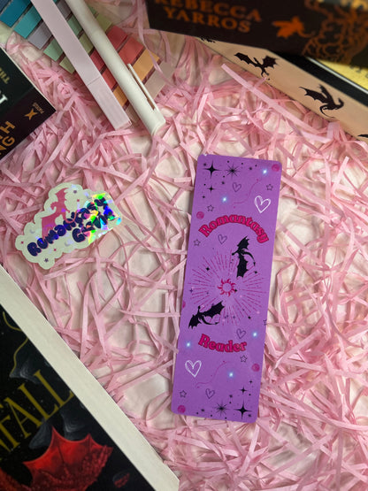 Purple 'Romantasy Reader' bookmark with a whimsical design featuring bats, stars, hearts, and a radiant sunburst