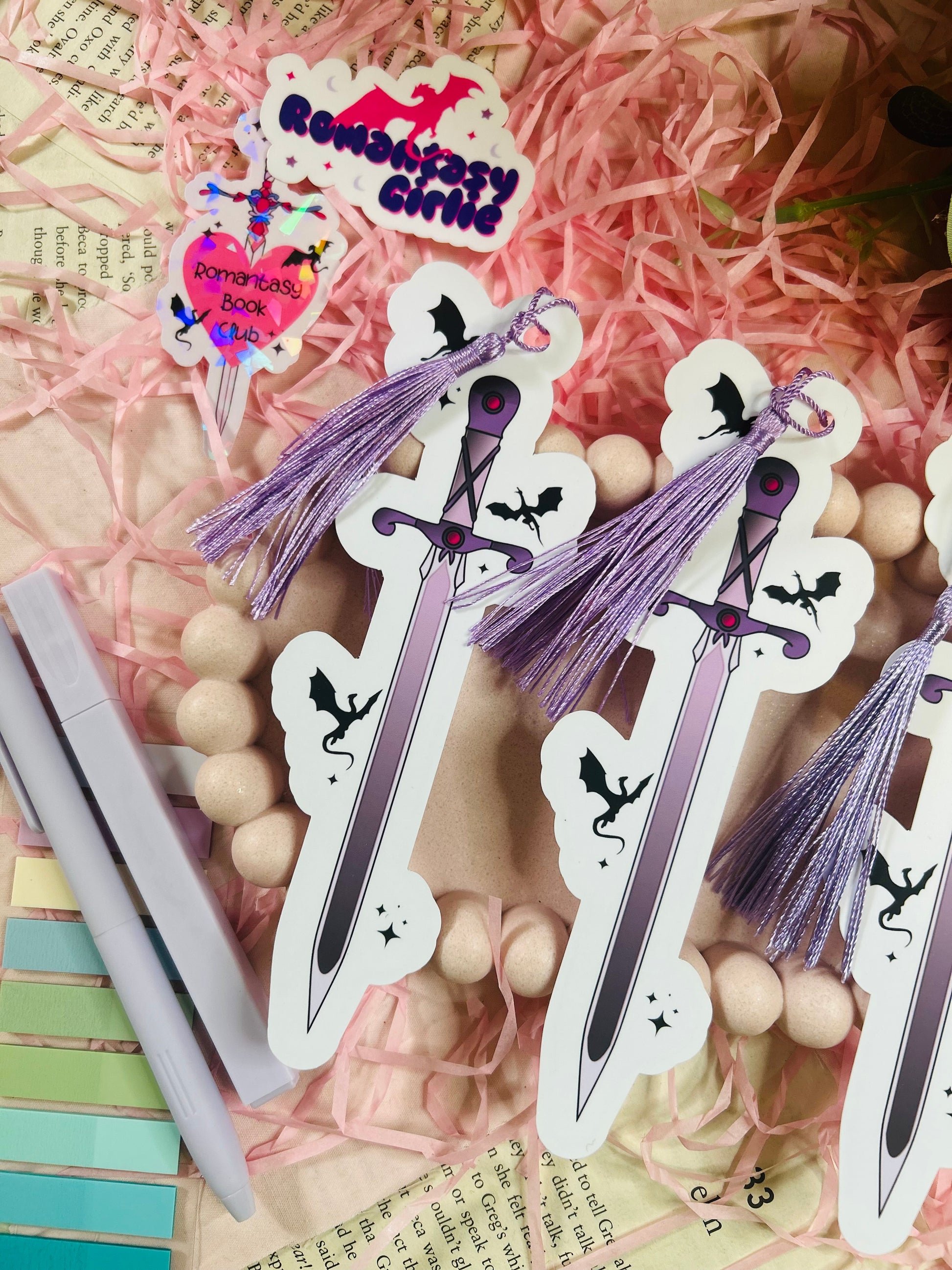 Bookmark featuring a fantasy sword surrounded by flying dragons, perfect for fans of epic fantasy and mythical adventures.