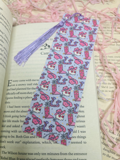 Double-sided purple western bookmark with cowboy skulls, snakes, boots, and hats in a bold design, perfect for dark western and romance readers.