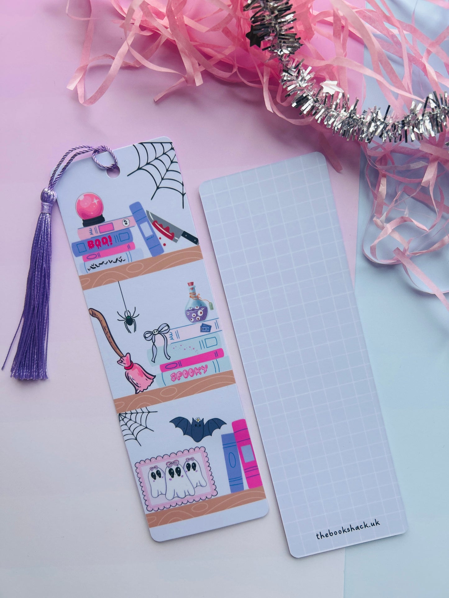 Decorative bookmark with tassel on a pink and white background