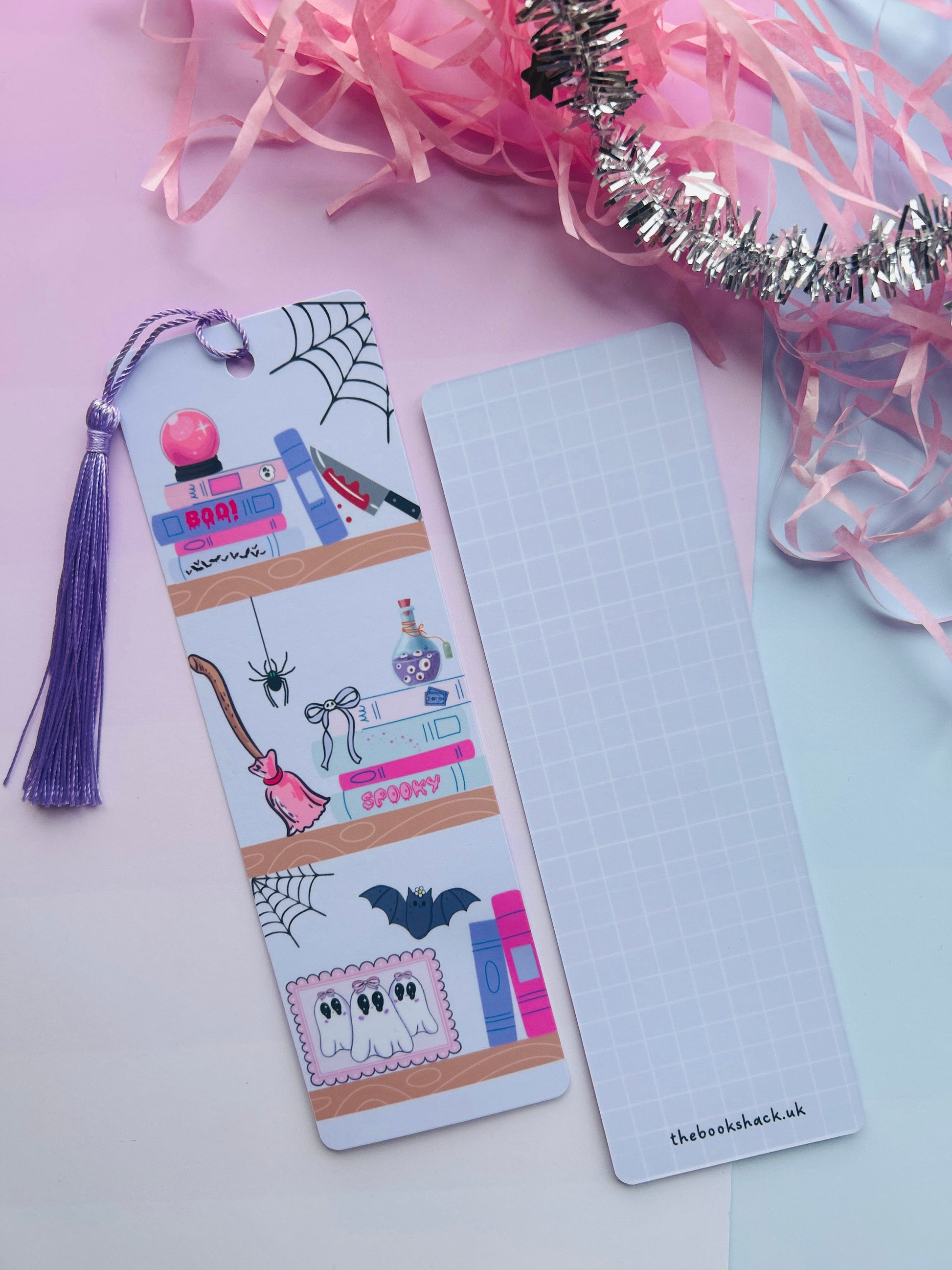 Decorative bookmark with tassel on a pink and white background
