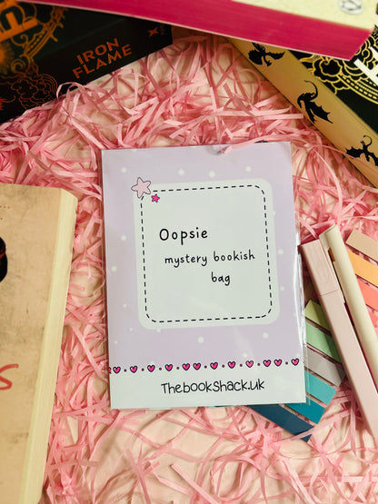 A colourful display of our Oopsie Mystery Grab Bag contents, featuring five unique bookish items such as bookmarks and stickers with minor imperfections.