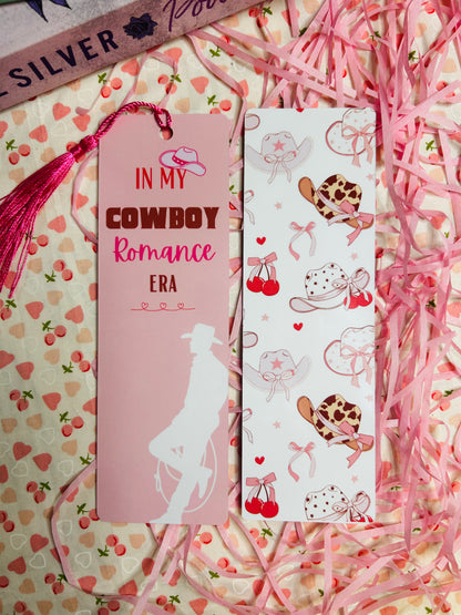 Pink cowboy-themed laminated bookmarks with tassels, featuring 'In My Cowboy Romance Era' text and cowboy hat patterns