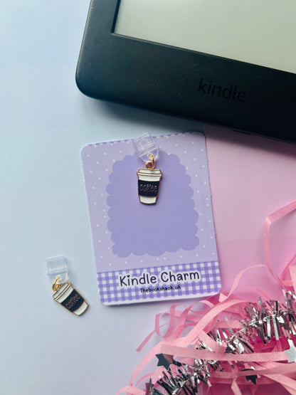 Kindle charm on a card with a Kindle device in the background
