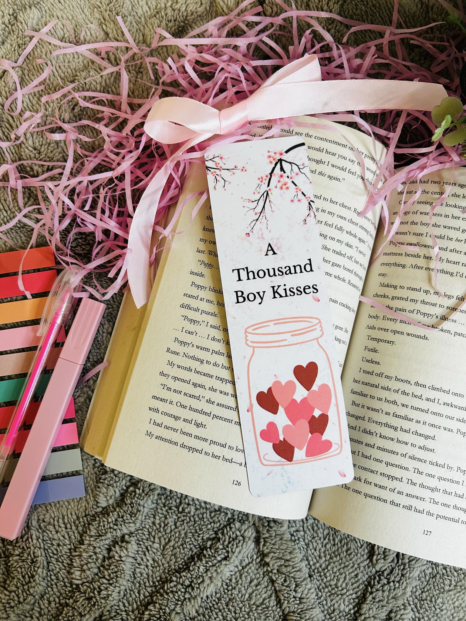"Beautiful 'A Thousand Boy Kisses' bookmark featuring a heart-filled jar and cherry blossom design