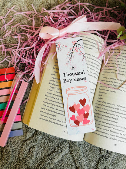 "Beautiful 'A Thousand Boy Kisses' bookmark featuring a heart-filled jar and cherry blossom design