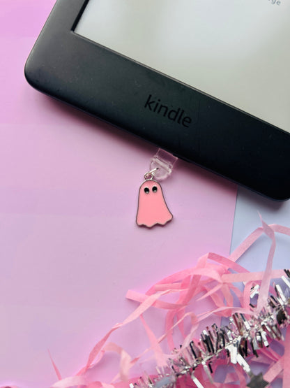 Pink ghost Kindle charm attached to a clear plastic Type-C dust plug, displayed with backing card and holographic packaging, with optional white letter charm.