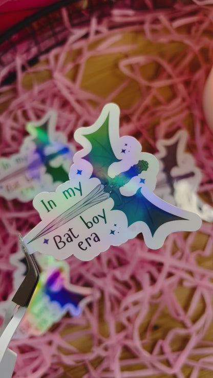 Holographic fantasy-themed sticker featuring a bat wing design and the phrase "In My Bat Boy Era,"