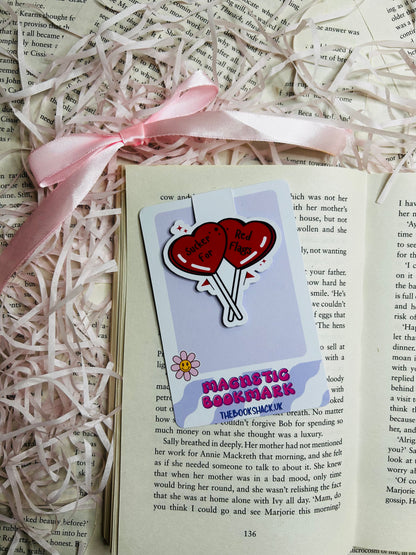 Magnetic bookmark featuring two vibrant red heart-shaped balloons with the playful text 'Sucker for Red Flags.' 