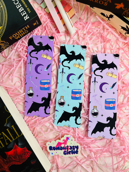 Fantasy-themed bookmarks featuring black dragon silhouettes, scrolls, potions, and celestial designs on vibrant backgrounds