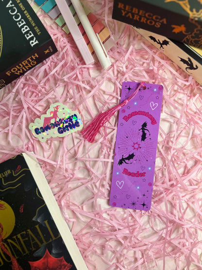 Purple 'Romantasy Reader' bookmark adorned with bats, hearts, stars, and a radiant sunburst design, enhanced by a pink tassel