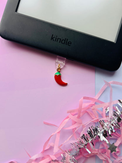 Spicy chilli Kindle charm attached to a clear plastic Type-C dust plug, shown with backing card and holographic packaging, with optional white letter charm.