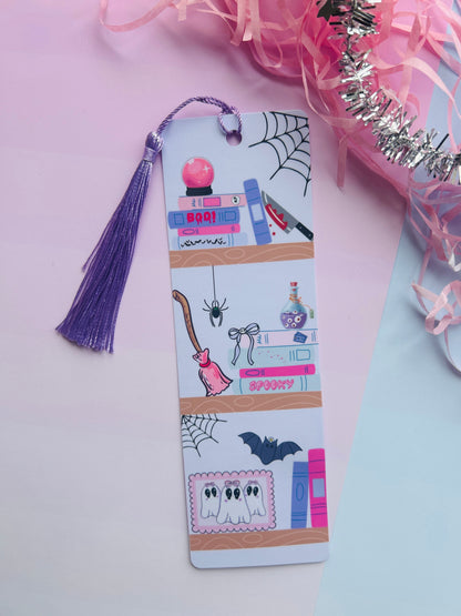 Decorative bookmark with Halloween-themed illustrations on a pink background