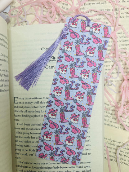 Double-sided purple western bookmark with cowboy skulls, snakes, boots, and hats in a bold design, perfect for dark western and romance readers.