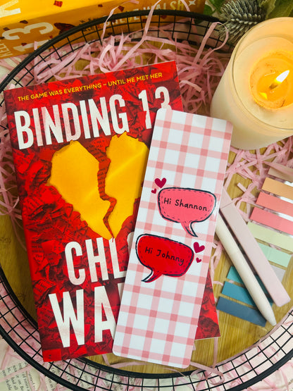Two pink gingham checked bookmarks inspired by Binding 13 by Chloe Walsh, featuring speech bubbles saying "Hi Shannon" and "Hi Johnny," surrounded by bookish accessories and soft pink aesthetic decor.