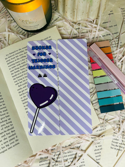 purple and white striped design sucker for trigger warnings bookmark