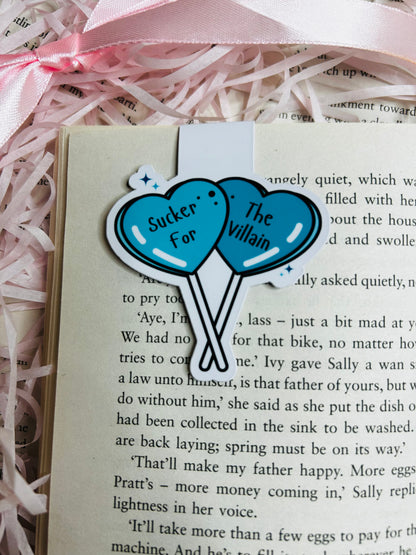 "Magnetic bookmark showcasing two striking blue heart-shaped balloons with the captivating phrase 'Sucker for The Villain.'