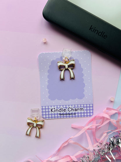 white bow Kindle charm attached to a clear plastic Type-C dust plug, displayed with backing card and holographic packaging, shown with optional white letter charm.