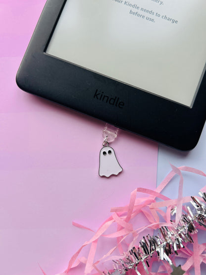 white ghost Kindle charm attached to a clear plastic Type-C dust plug, displayed with backing card and holographic packaging, with optional white letter charm.